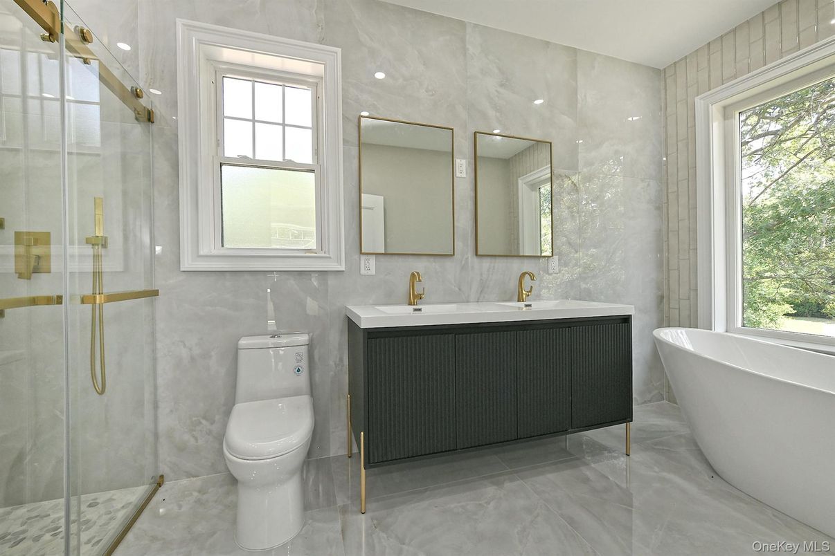 Bathroom, Dual Sink Vanities, Free Standing Baths, Glass Shower, Interior, Marble Walls, Recessed Lighting