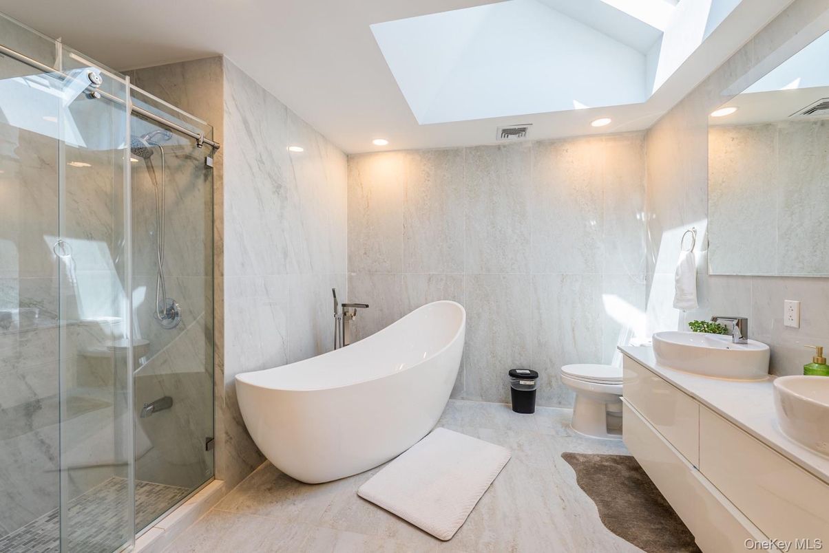 Bathroom, Dual Sink Vanities, Free Standing Baths, Glass Shower, Interior, Marble Walls, Recessed Lighting
