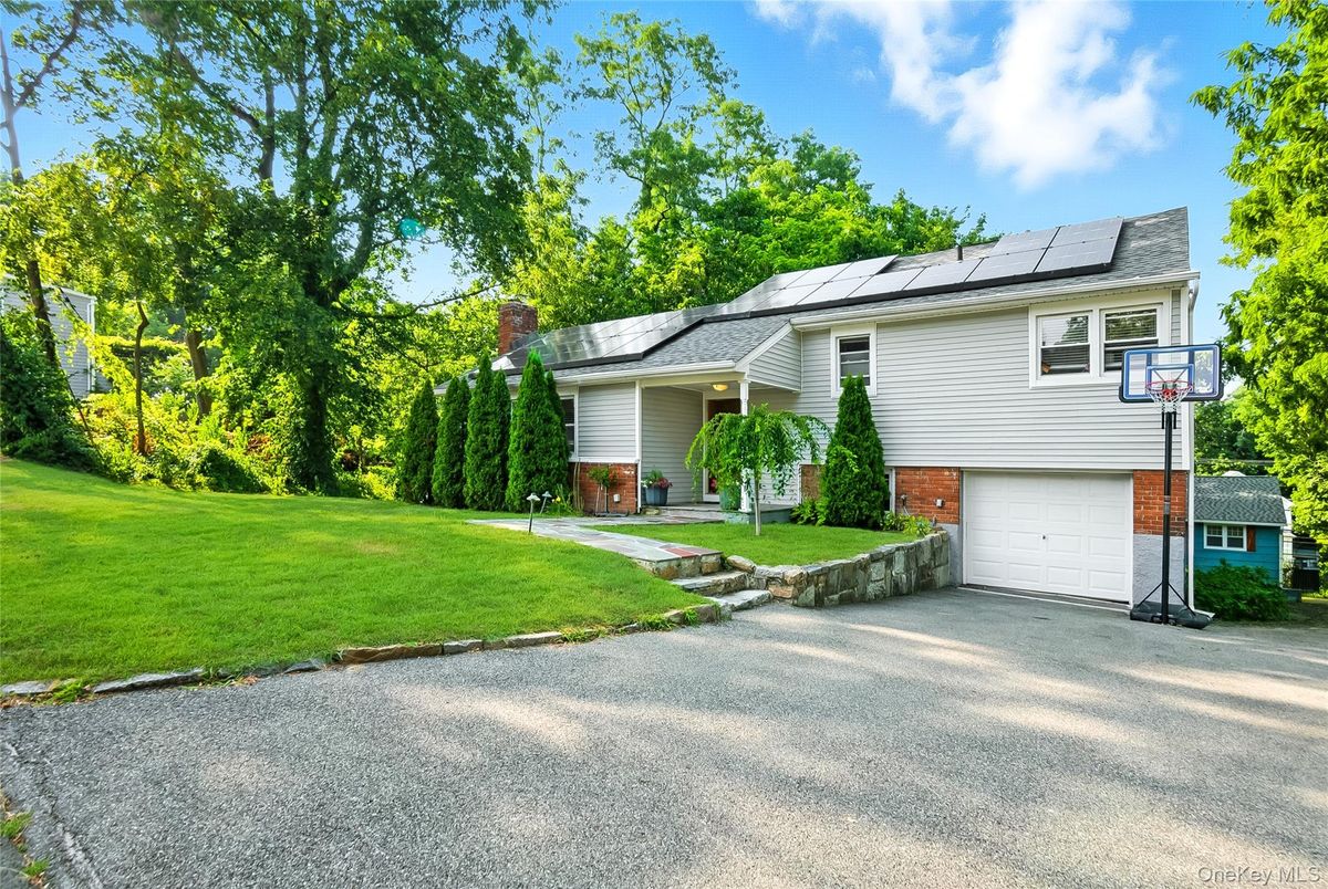 Attached, Backyard, Exterior, Facade, Brick Facade, Solar Panels, Raised Ranch