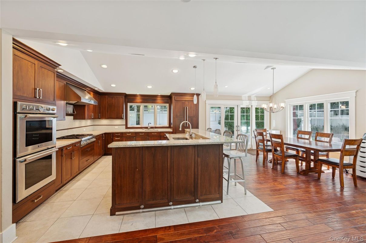 Chandelier, Dining room, Interior, Kitchen, Pendant Lights, Recessed Lighting, Stainless Steel Appliances, Wood Texture Flooring