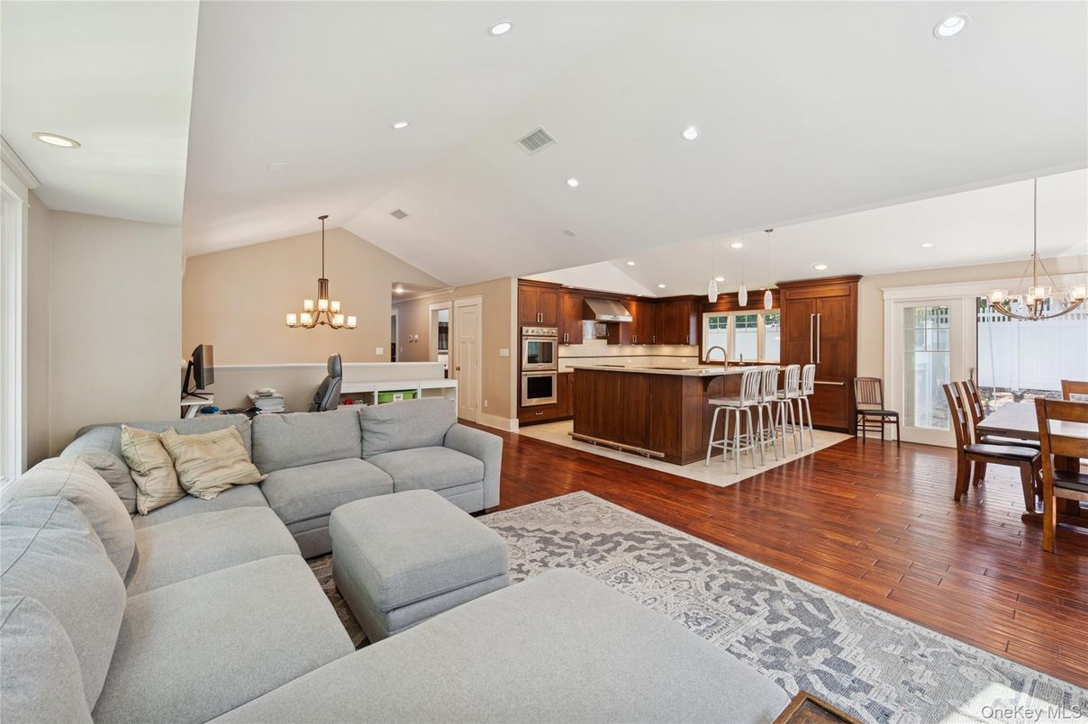 Chandelier, Dining room, Interior, Kitchen, Living room, Pendant Lights, Recessed Lighting, Stainless Steel Appliances, Wood Texture Flooring