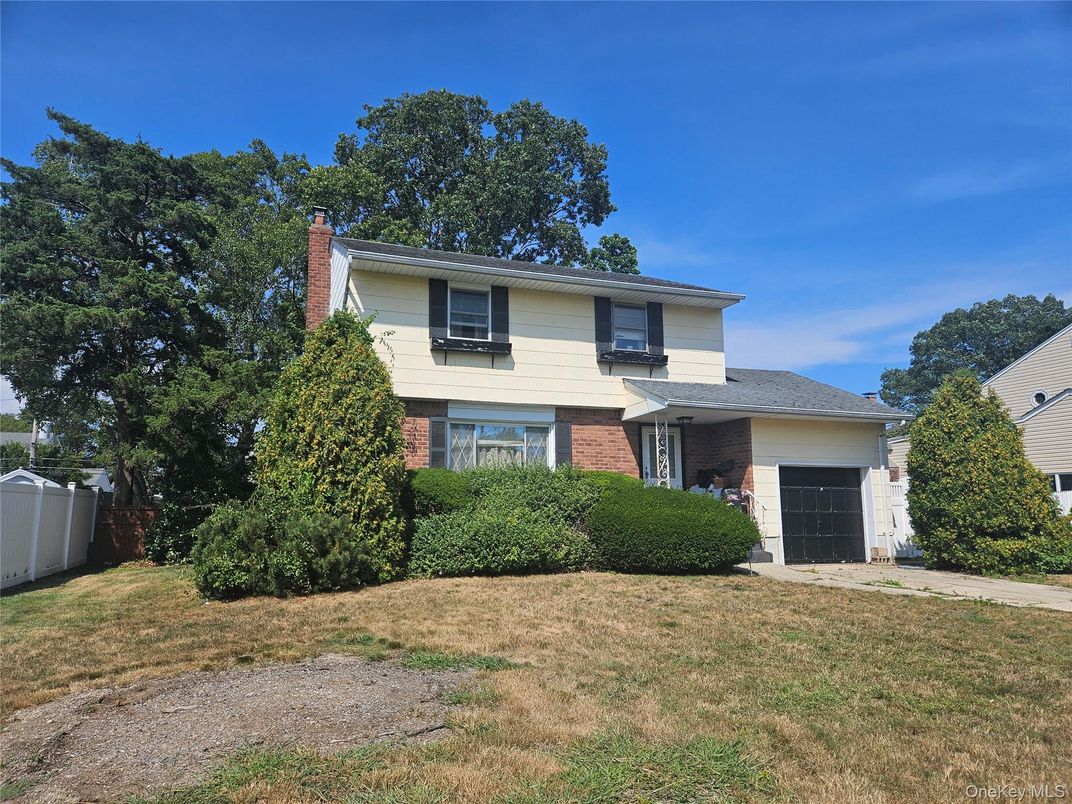 Attached, Backyard, Exterior, Facade, Brick Facade, Split Level
