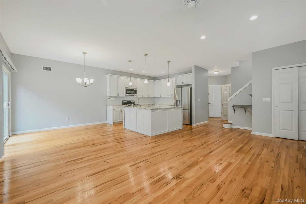 Chandelier, Empty room, Interior, Kitchen, Pendant Lights, Recessed Lighting, Stainless Steel Appliances, Wood Texture Flooring