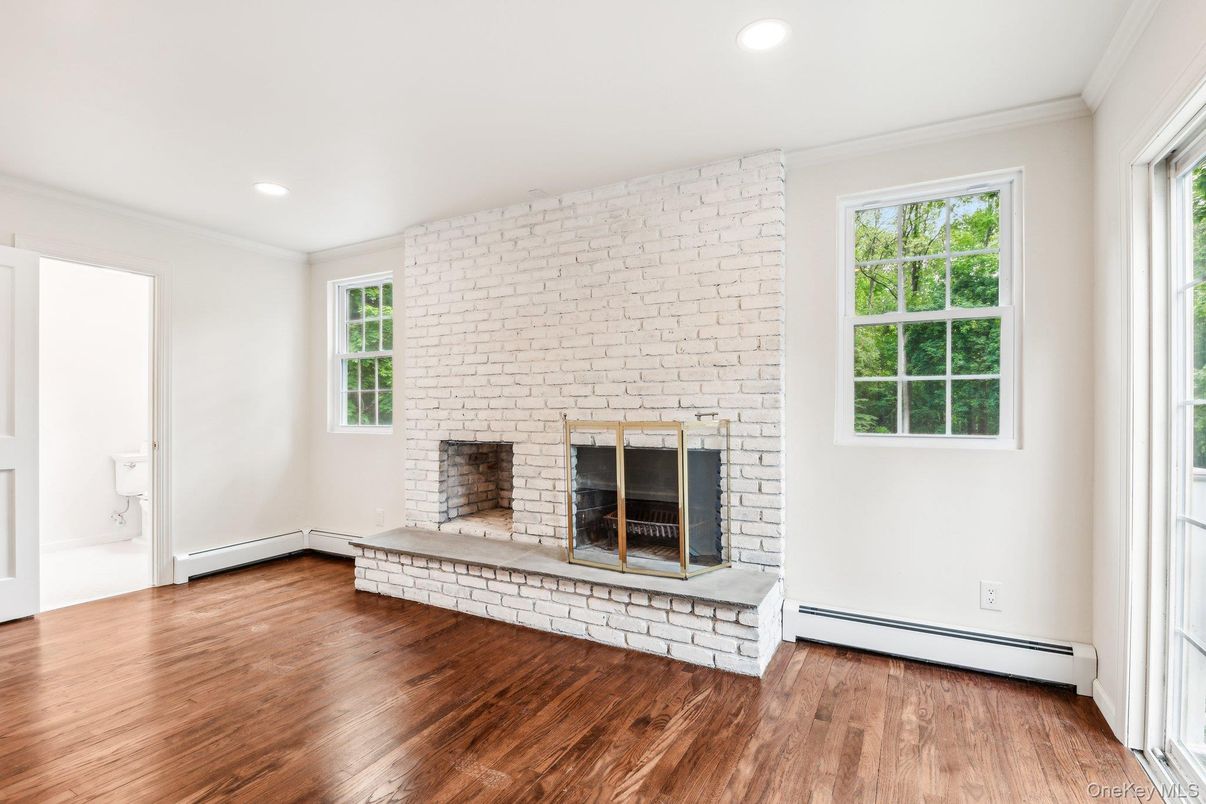 Empty room, Fireplace, Interior, Recessed Lighting, Stone Walls, Wood Texture Flooring