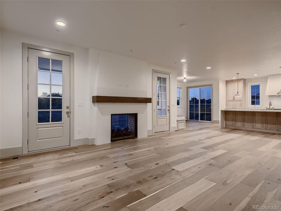Empty room, Fireplace, Interior, Kitchen, Pendant Lights, Recessed Lighting, Wood Texture Flooring