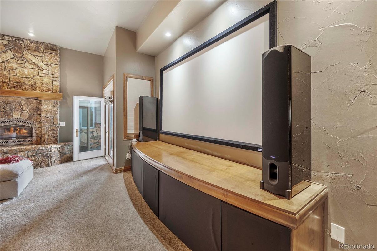 Fireplace, Interior, Projection Screen, Recessed Lighting, Stone Walls