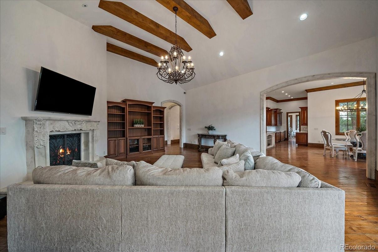 Chandelier, Dining room, Fireplace, Interior, Living room, Recessed Lighting, Wooden Beams, Wood Texture Flooring