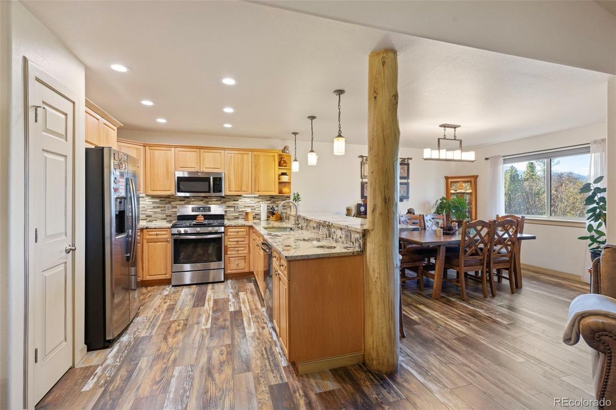 Dining room, Interior, Kitchen, Pendant Lights, Recessed Lighting, Stainless Steel Appliances, Wood Texture Flooring