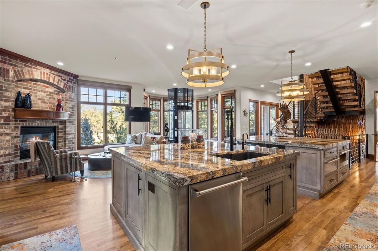 Chandelier, Fireplace, Interior, Kitchen, Living room, Pendant Lights, Recessed Lighting, Stainless Steel Appliances, Stone Walls, Wood Texture Flooring