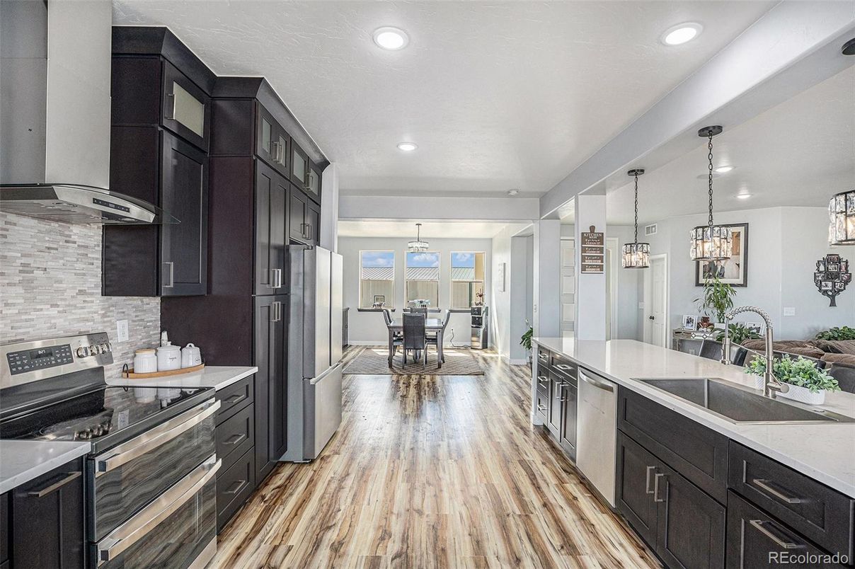 Dining room, Interior, Kitchen, Pendant Lights, Recessed Lighting, Stainless Steel Appliances, Wood Texture Flooring
