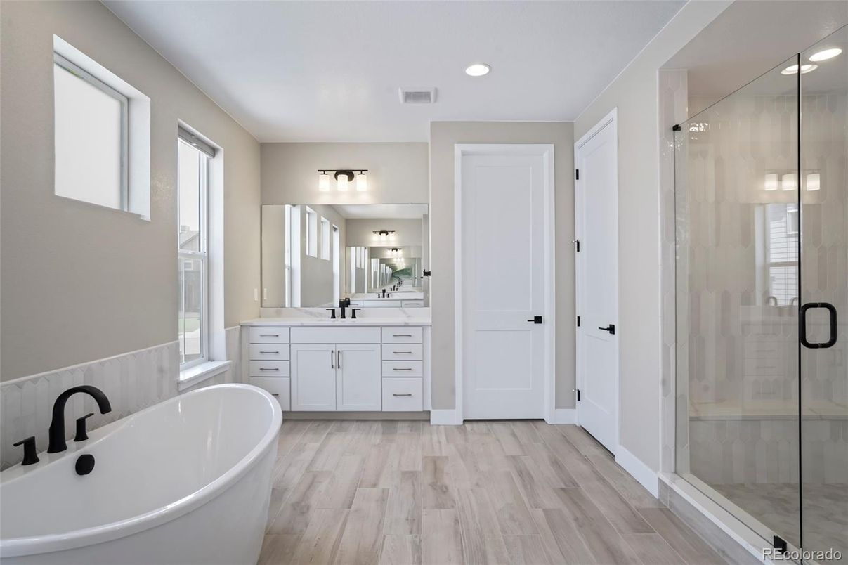 Bathroom, Dual Sink Vanities, Free Standing Baths, Glass Shower, Interior, Recessed Lighting, Wood Texture Flooring