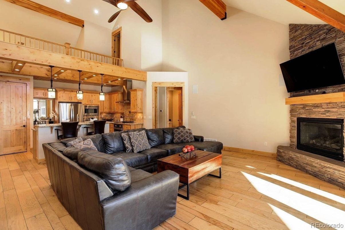 Fireplace, Interior, Kitchen, Living room, Pendant Lights, Recessed Lighting, Stainless Steel Appliances, Wooden Beams, Wood Texture Flooring
