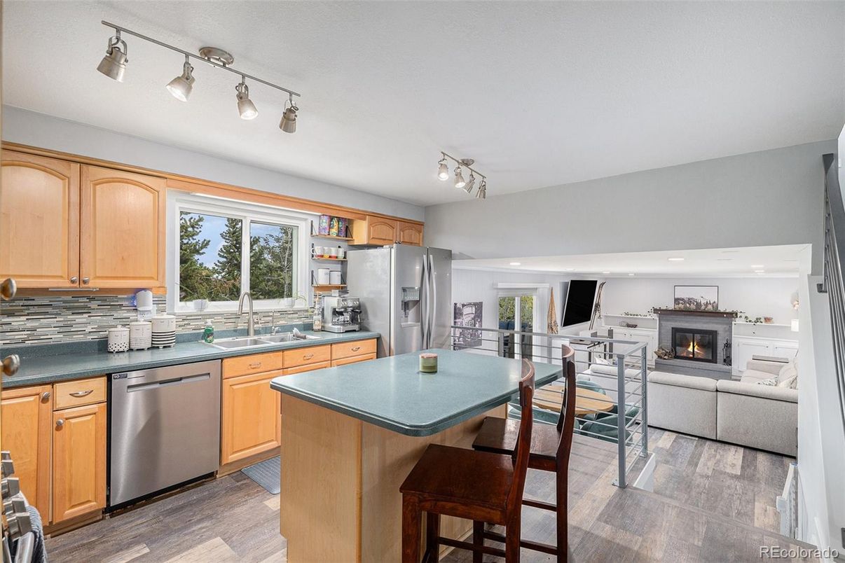 Dining room, Fireplace, Interior, Kitchen, Living room, Recessed Lighting, Stainless Steel Appliances, Wood Texture Flooring