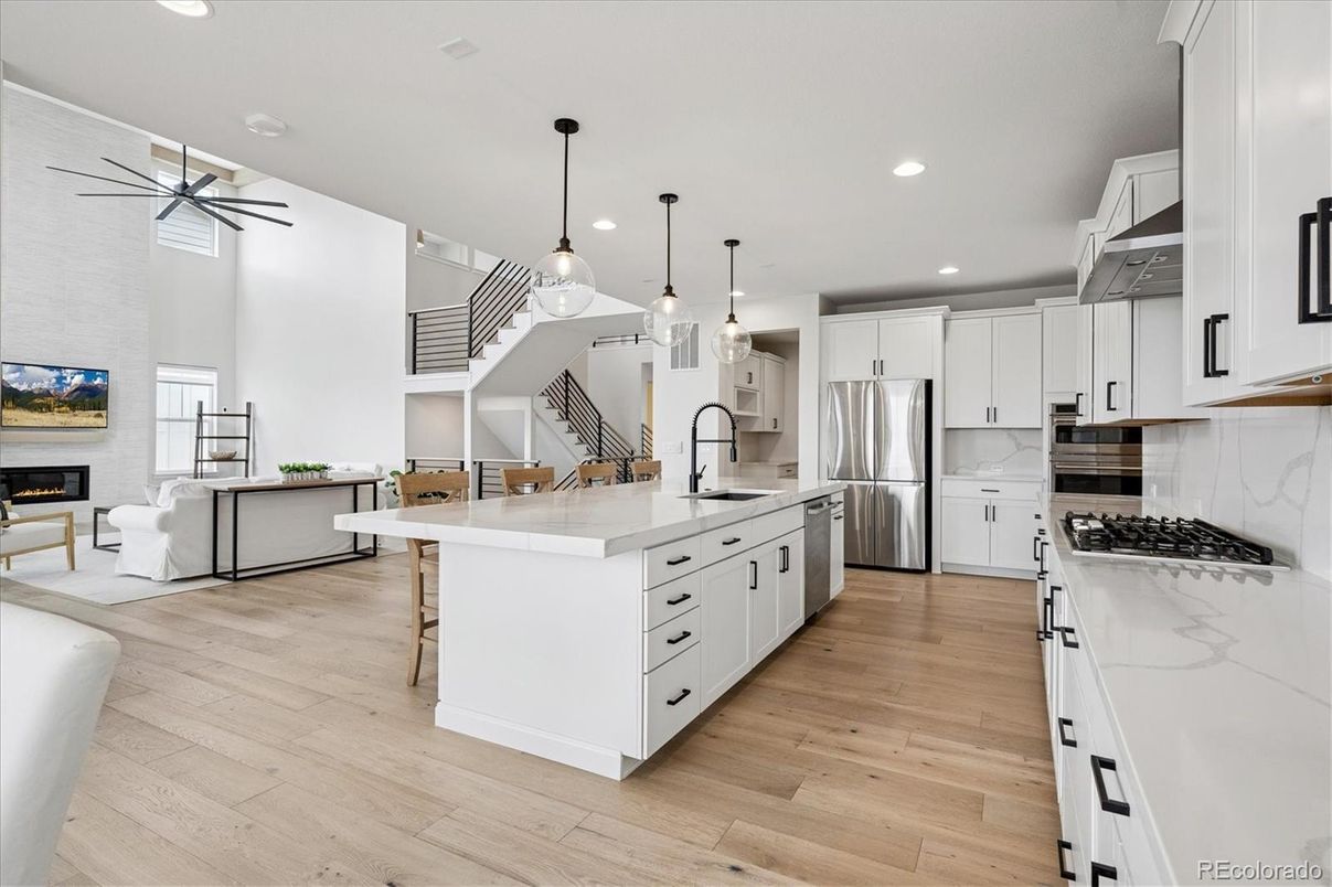 Fireplace, Interior, Kitchen, Living room, Pendant Lights, Recessed Lighting, Stainless Steel Appliances, Wood Texture Flooring