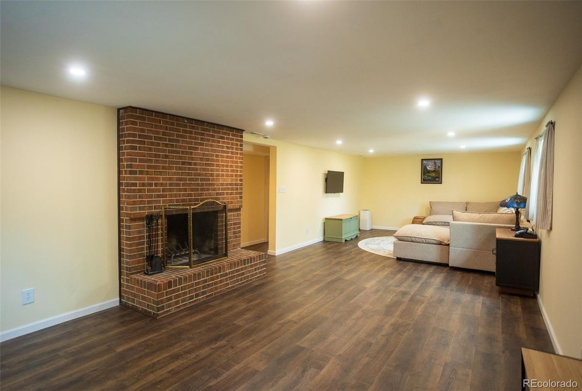 Fireplace, Interior, Living room, Recessed Lighting, Stone Walls, Wood Texture Flooring