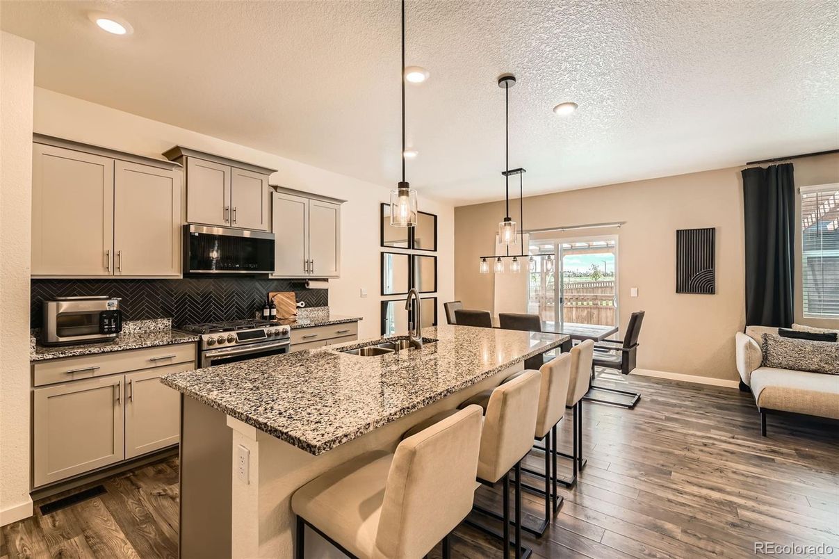 Dining room, Interior, Kitchen, Pendant Lights, Recessed Lighting, Stainless Steel Appliances, Wood Texture Flooring