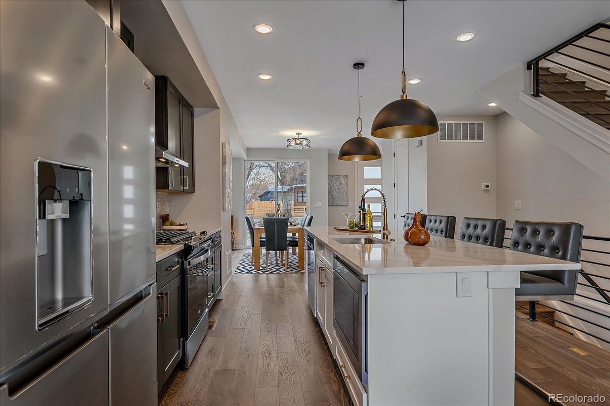 Dining room, Interior, Kitchen, Pendant Lights, Recessed Lighting, Stainless Steel Appliances, Wood Texture Flooring