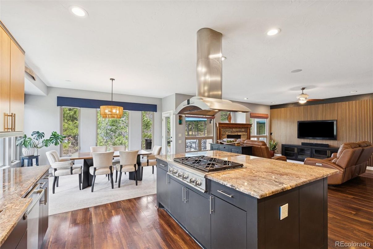 Chandelier, Dining room, Fireplace, Interior, Kitchen, Living room, Pendant Lights, Recessed Lighting, Stainless Steel Appliances, Wood Texture Flooring
