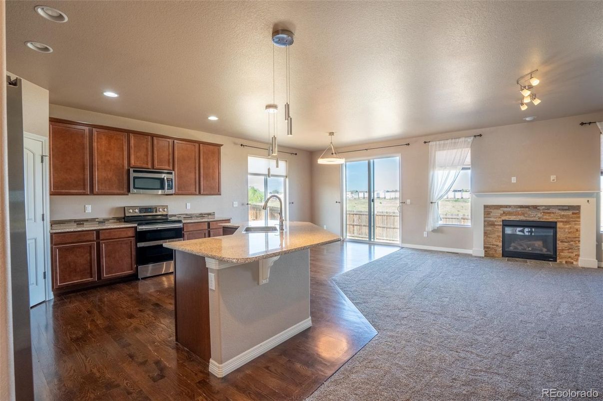 Fireplace, Interior, Kitchen, Pendant Lights, Recessed Lighting, Stainless Steel Appliances, Wood Texture Flooring