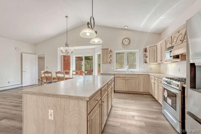 Chandelier, Dining room, Interior, Kitchen, Pendant Lights, Recessed Lighting, Stainless Steel Appliances, Wood Texture Flooring