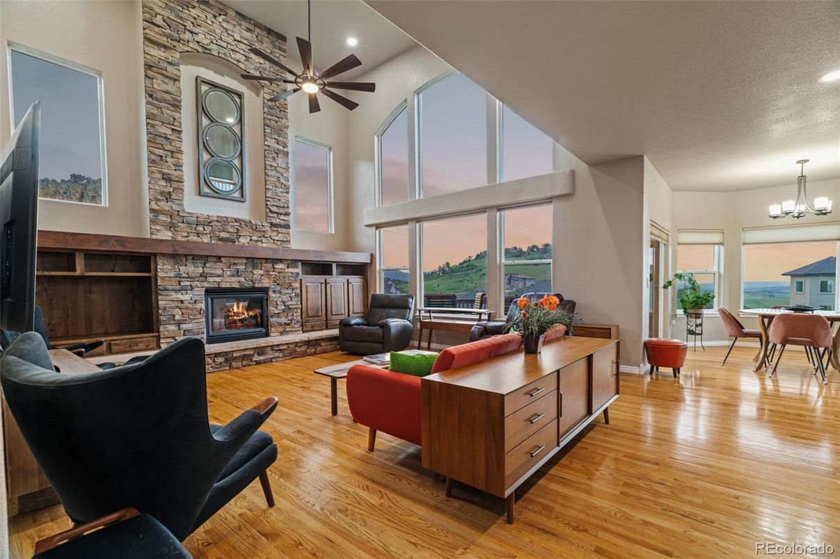 Chandelier, Dining room, Fireplace, Interior, Living room, Recessed Lighting, Stone Walls, Water, Wood Texture Flooring