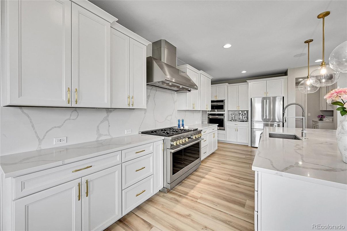 Interior, Kitchen, Marble Walls, Pendant Lights, Recessed Lighting, Stainless Steel Appliances, Wood Texture Flooring