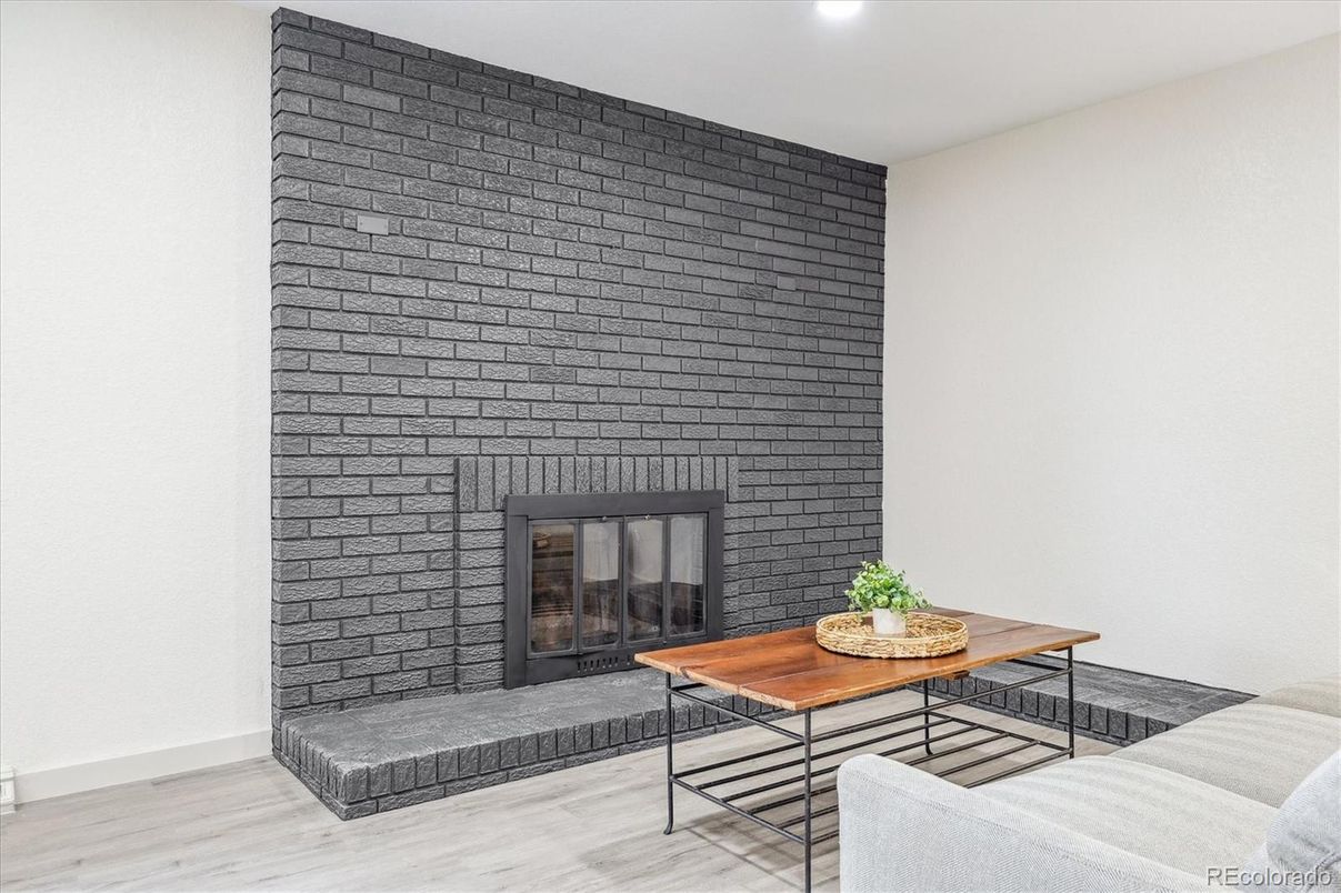 Fireplace, Interior, Living room, Recessed Lighting, Stone Walls, Wood Texture Flooring