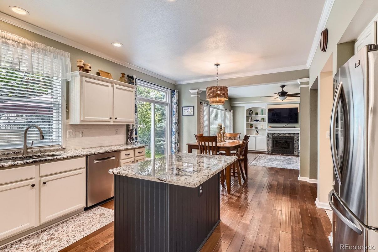 Chandelier, Dining room, Fireplace, Interior, Kitchen, Pendant Lights, Recessed Lighting, Stainless Steel Appliances, Wood Texture Flooring