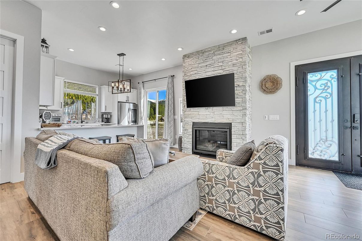 Fireplace, Interior, Living room, Pendant Lights, Recessed Lighting, Stone Walls, Wood Texture Flooring