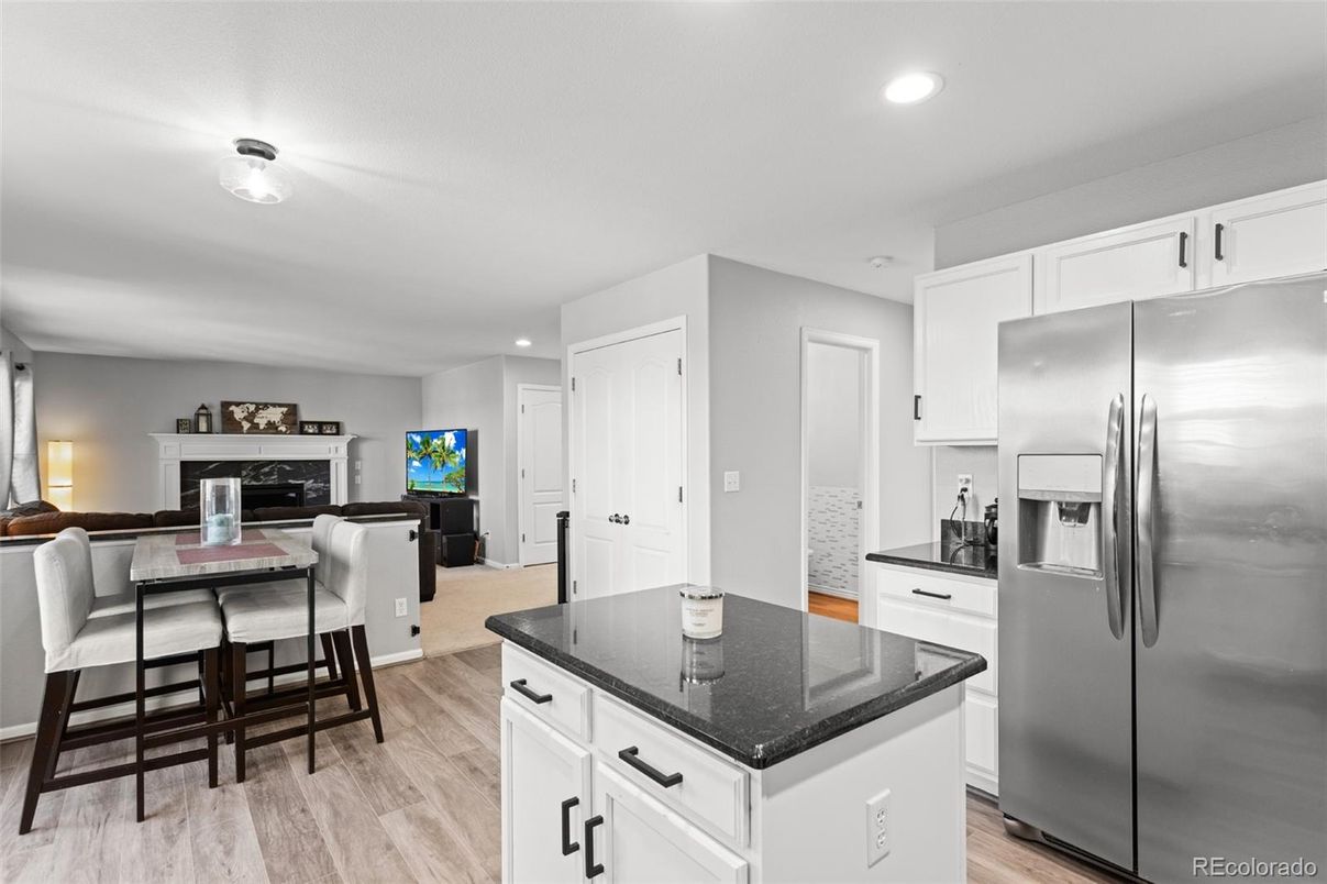 Dining room, Fireplace, Interior, Kitchen, Living room, Recessed Lighting, Stainless Steel Appliances, Wood Texture Flooring