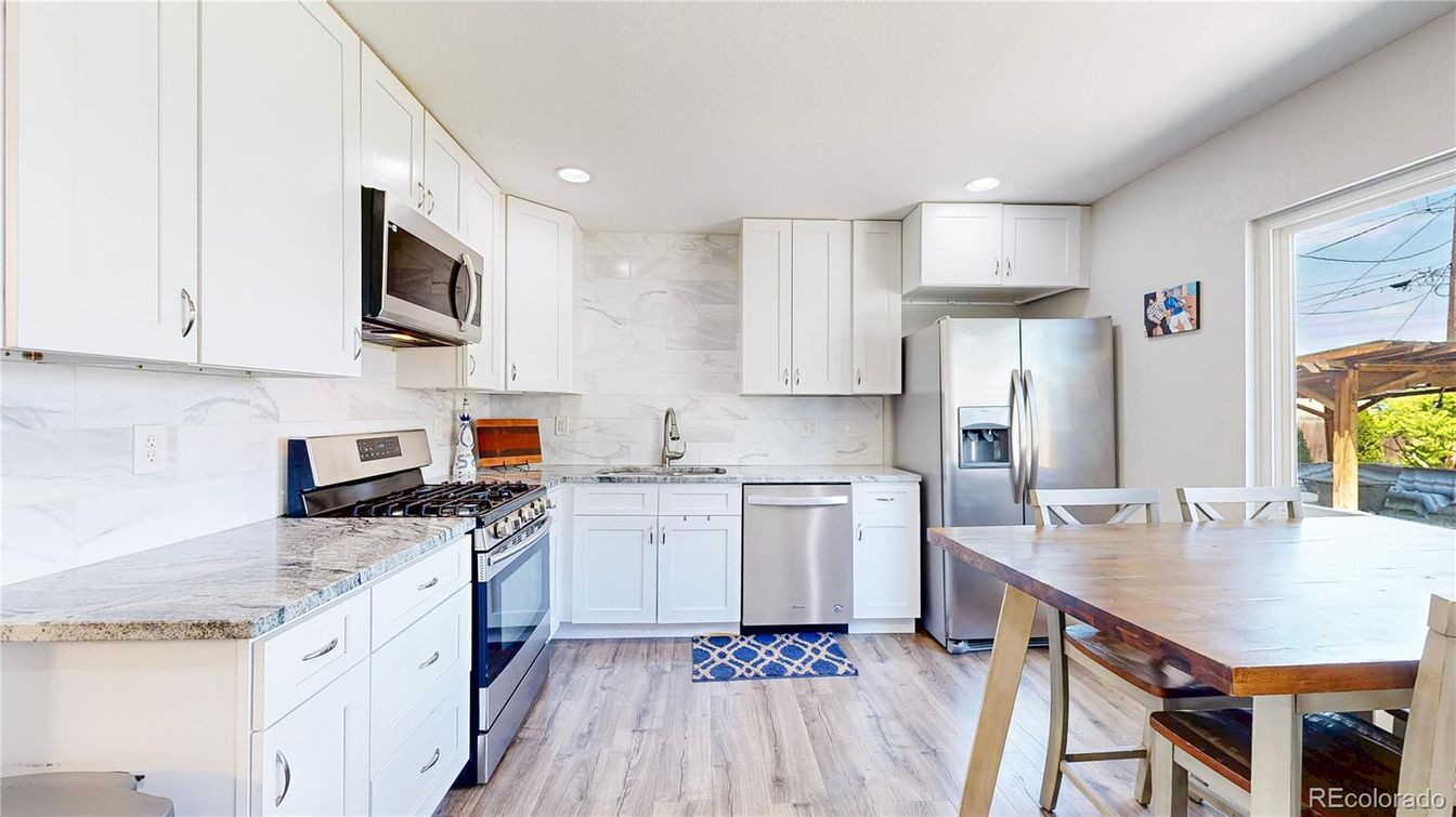 Interior, Kitchen, Marble Walls, Recessed Lighting, Stainless Steel Appliances, Wood Texture Flooring
