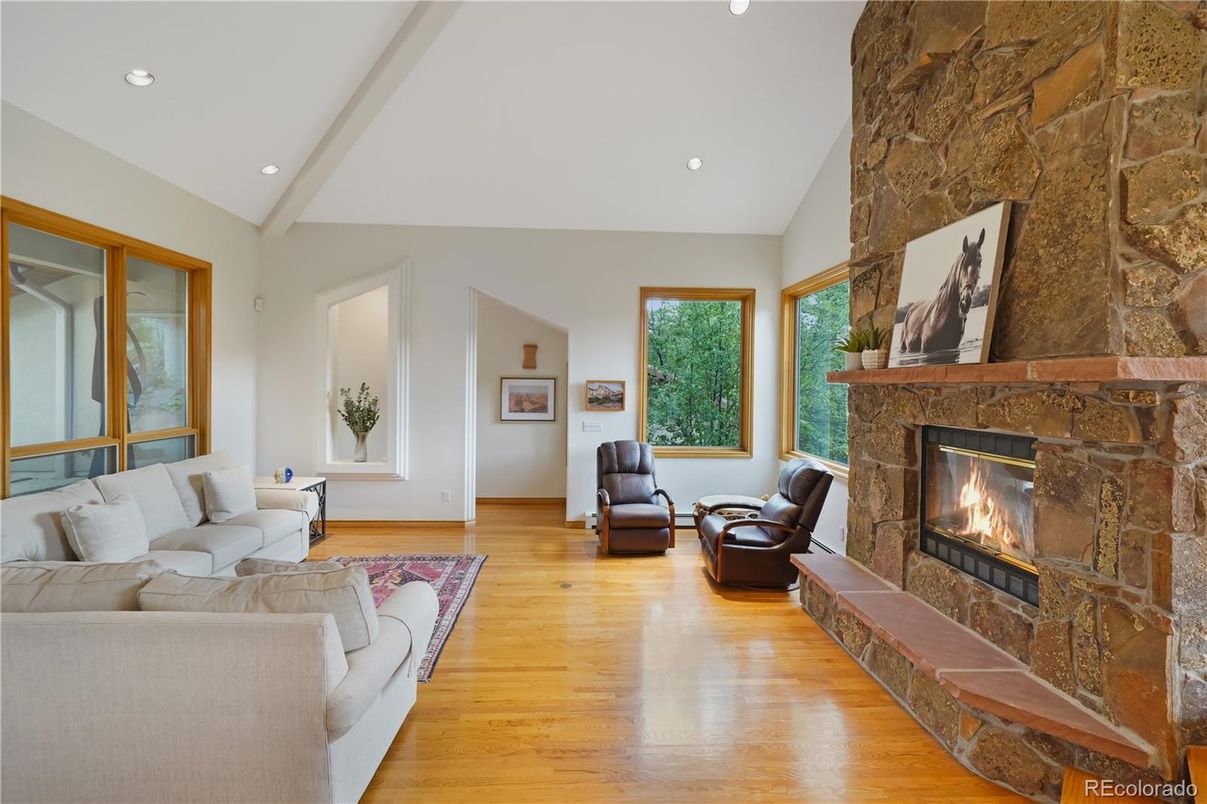 Fireplace, Interior, Living room, Recessed Lighting, Stone Walls, Wood Texture Flooring
