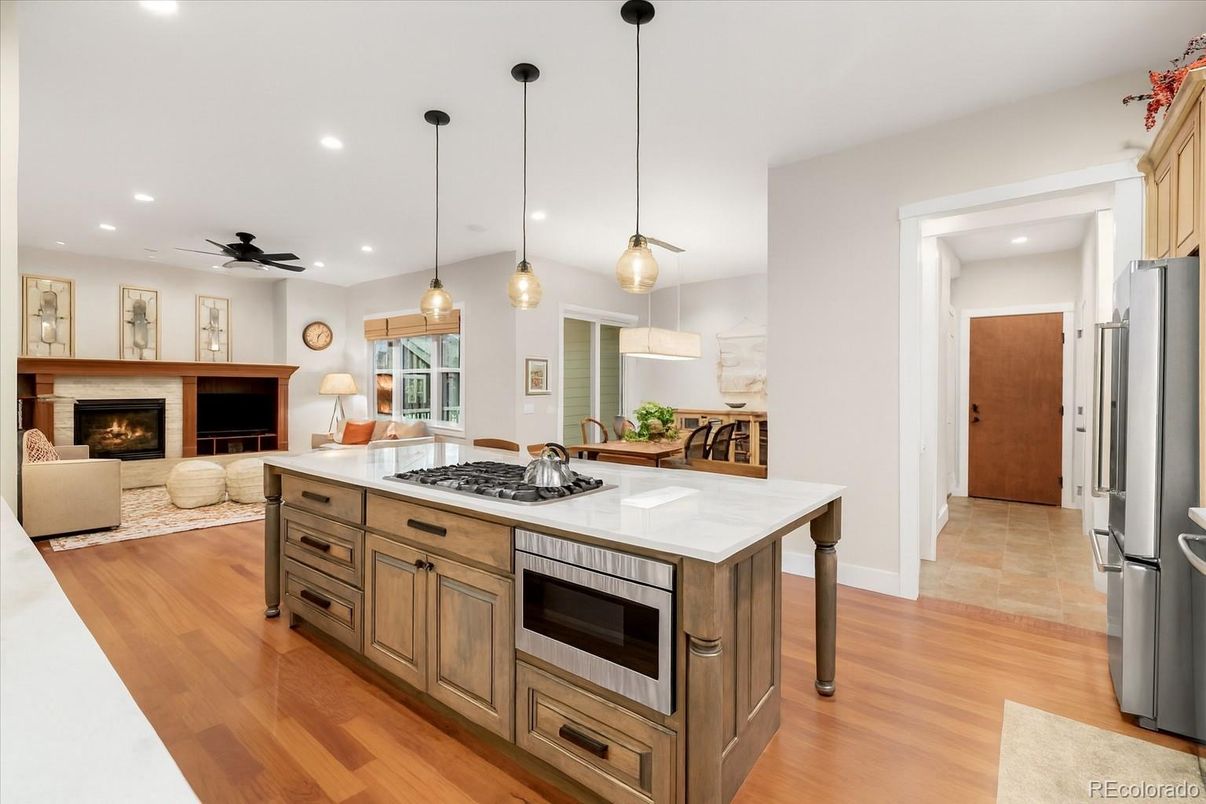 Fireplace, Interior, Kitchen, Living room, Pendant Lights, Recessed Lighting, Stainless Steel Appliances, Wood Texture Flooring