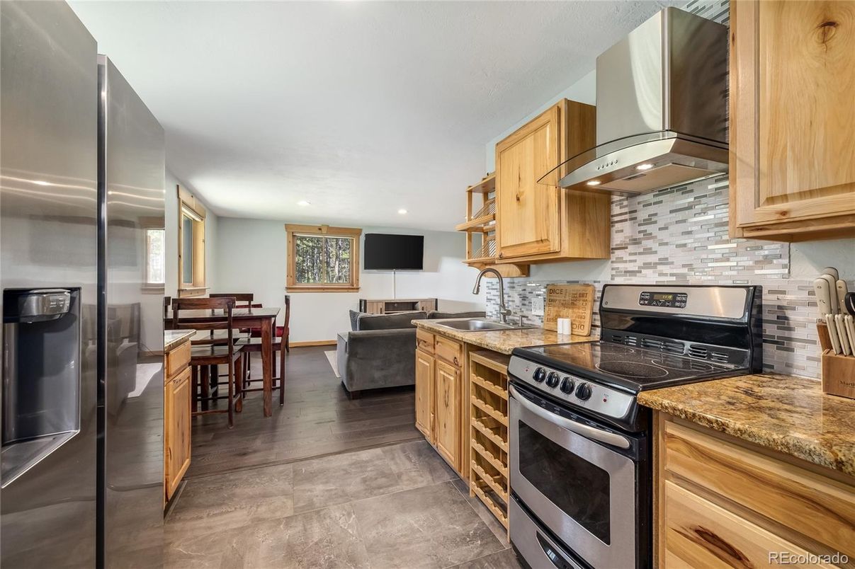 Dining room, Interior, Kitchen, Living room, Recessed Lighting, Stainless Steel Appliances, Wood Texture Flooring
