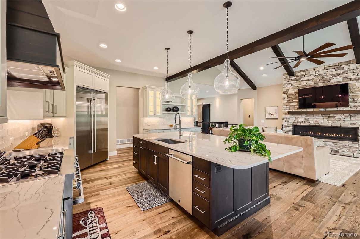 Fireplace, Interior, Kitchen, Living room, Pendant Lights, Recessed Lighting, Stainless Steel Appliances, Stone Walls, Wood Texture Flooring