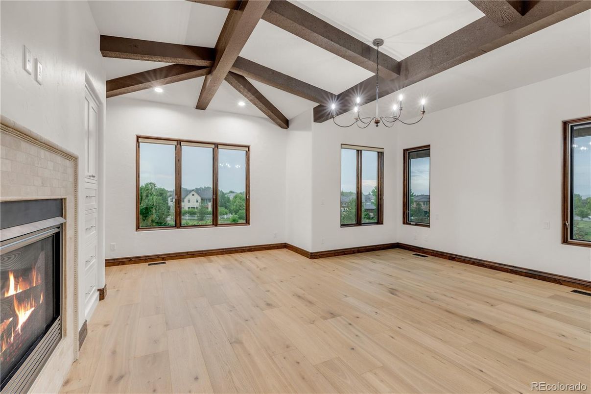 Chandelier, Empty room, Fireplace, Interior, Recessed Lighting, Wooden Beams, Wood Texture Flooring