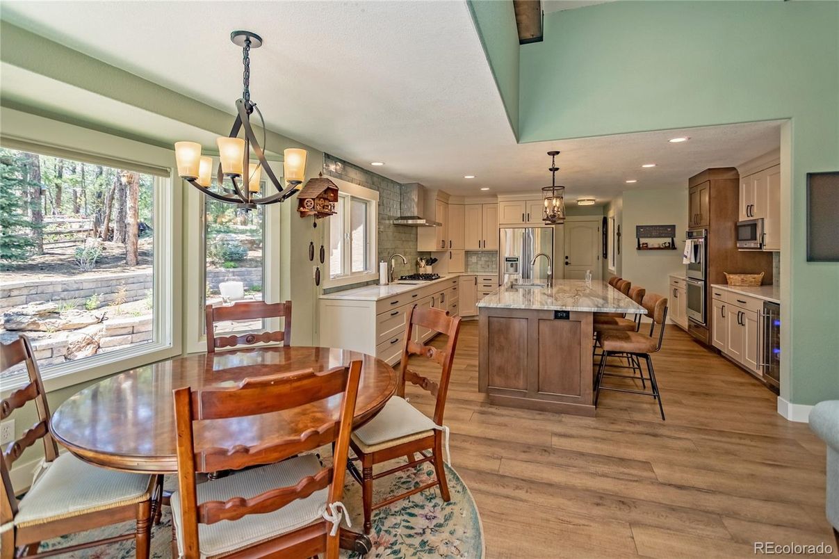 Chandelier, Dining room, Interior, Kitchen, Pendant Lights, Recessed Lighting, Stainless Steel Appliances, Wood Texture Flooring