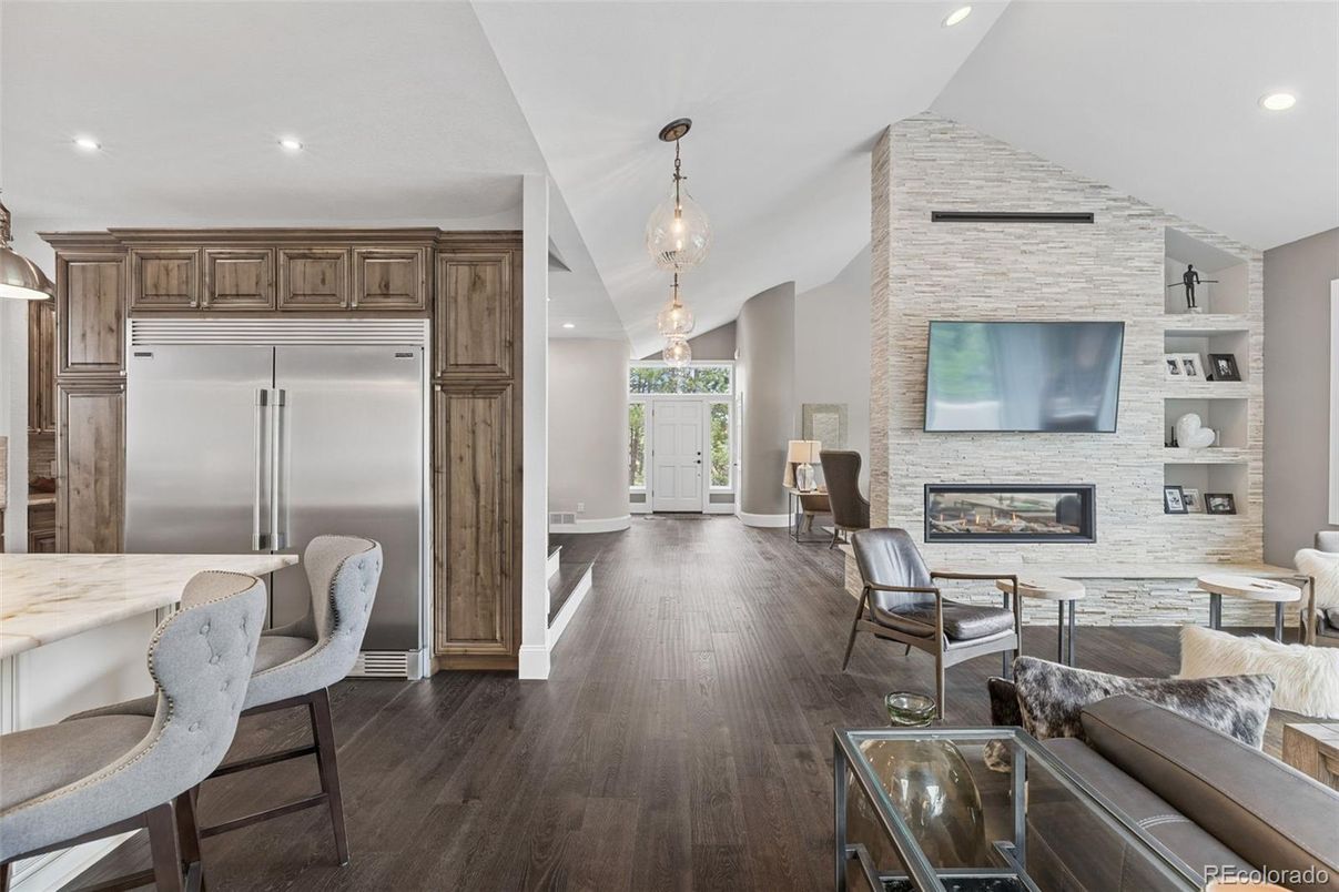 Fireplace, Interior, Kitchen, Living room, Pendant Lights, Recessed Lighting, Stainless Steel Appliances, Stone Walls, Wood Texture Flooring