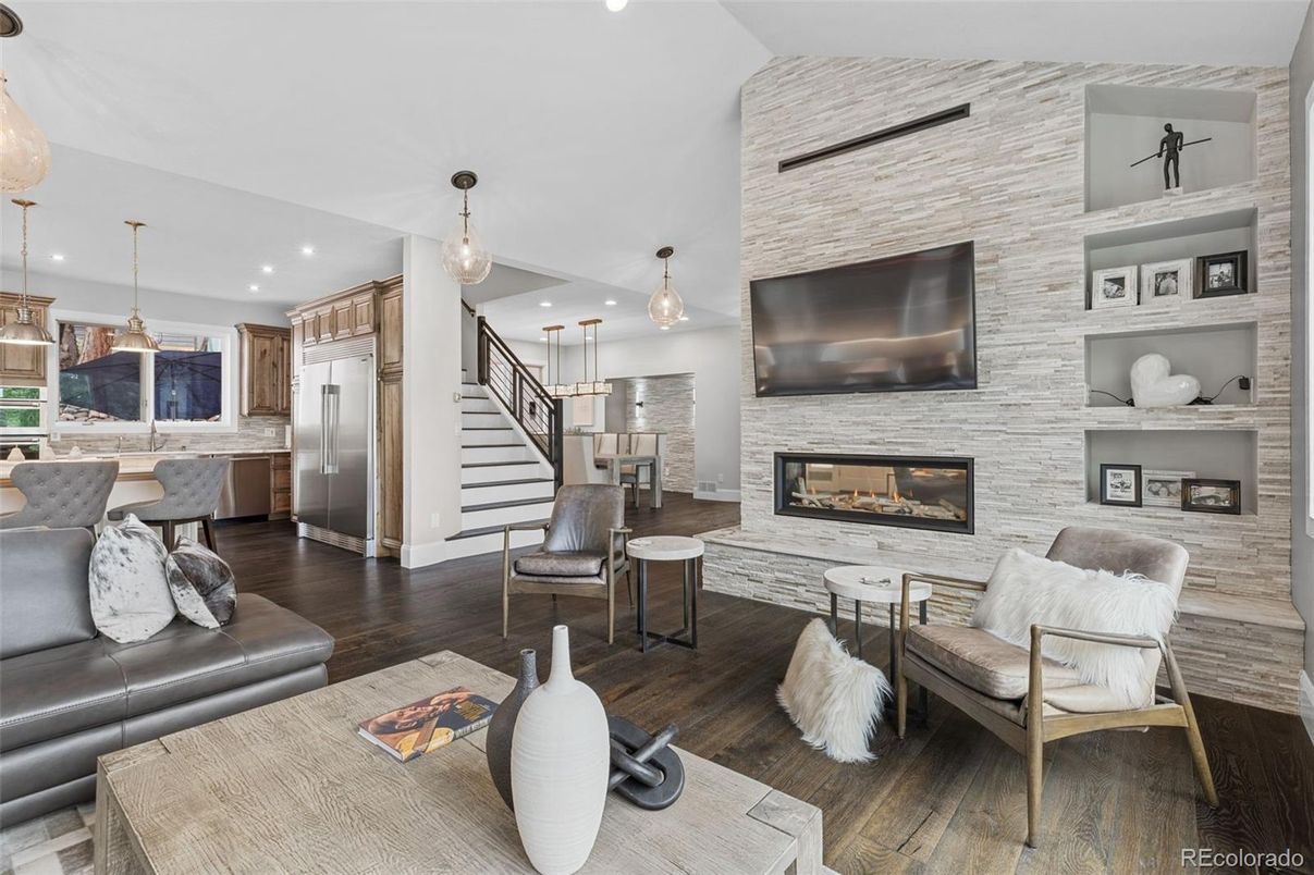 Fireplace, Interior, Kitchen, Living room, Pendant Lights, Recessed Lighting, Stainless Steel Appliances, Stone Walls, Wood Texture Flooring
