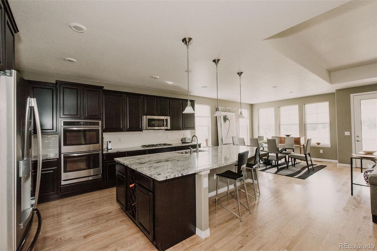 Dining room, Interior, Kitchen, Pendant Lights, Recessed Lighting, Stainless Steel Appliances, Wood Texture Flooring