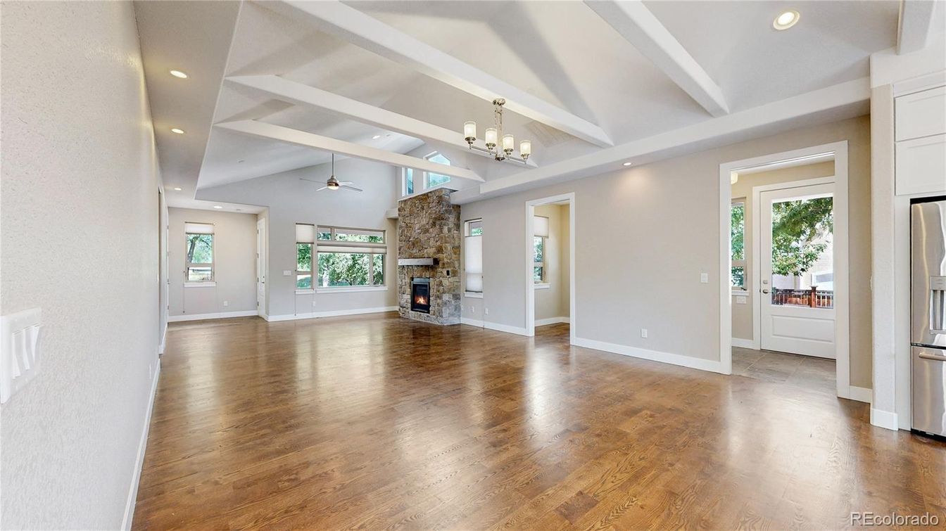 Chandelier, Empty room, Fireplace, Interior, Recessed Lighting, Stone Walls, Wood Texture Flooring