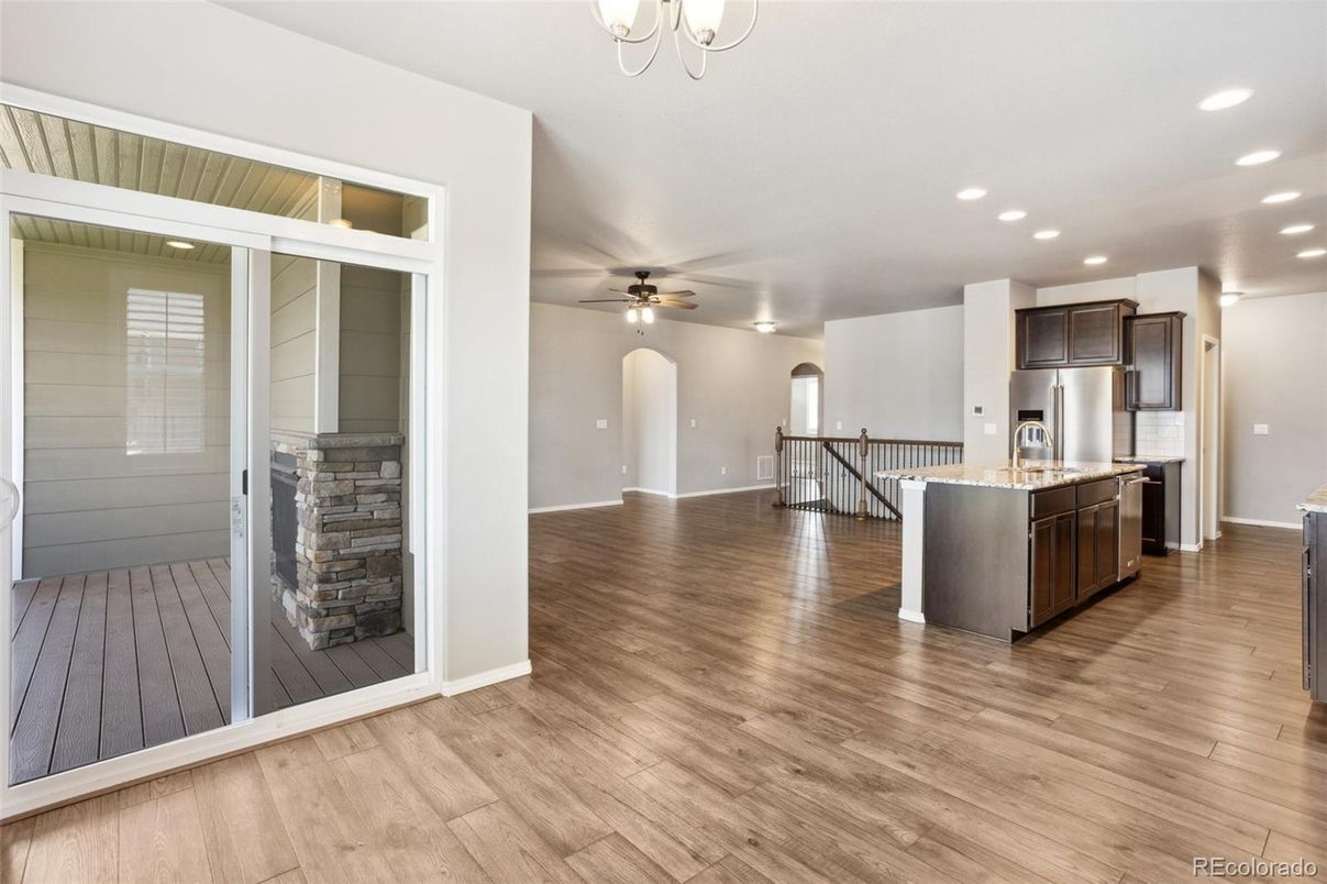 Empty room, Interior, Kitchen, Recessed Lighting, Stainless Steel Appliances, Wood Texture Flooring