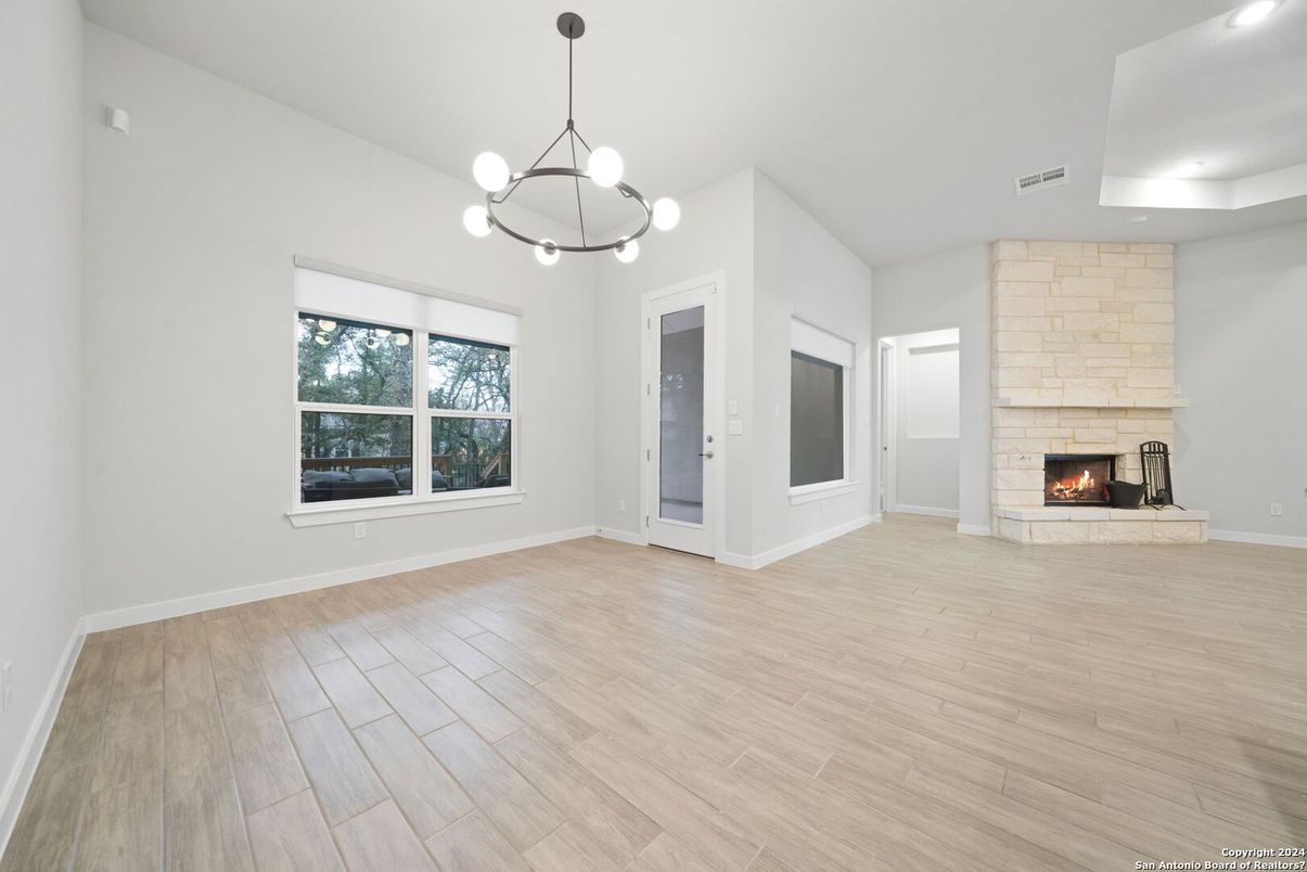 Empty room, Fireplace, Interior, Pendant Lights, Recessed Lighting, Wood Texture Flooring