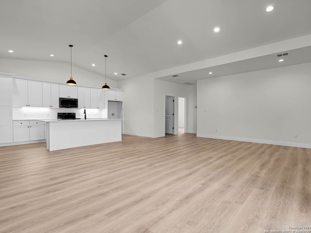 Empty room, Interior, Kitchen, Pendant Lights, Recessed Lighting, Stainless Steel Appliances, Wood Texture Flooring