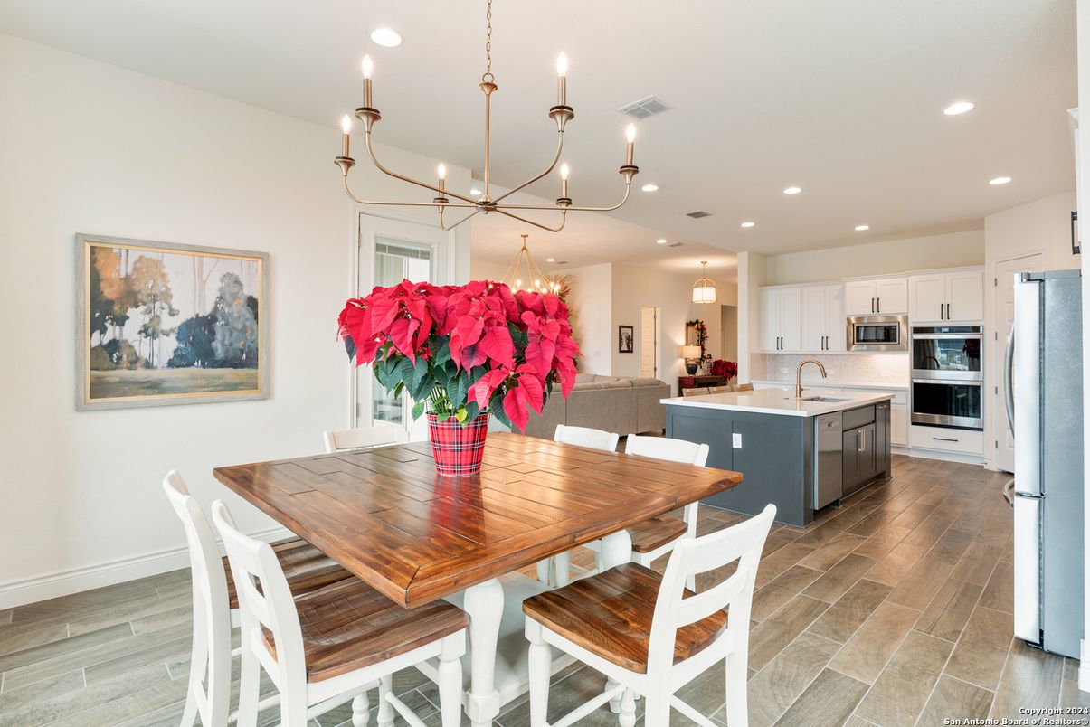 Chandelier, Dining room, Interior, Kitchen, Pendant Lights, Recessed Lighting, Stainless Steel Appliances, Wood Texture Flooring