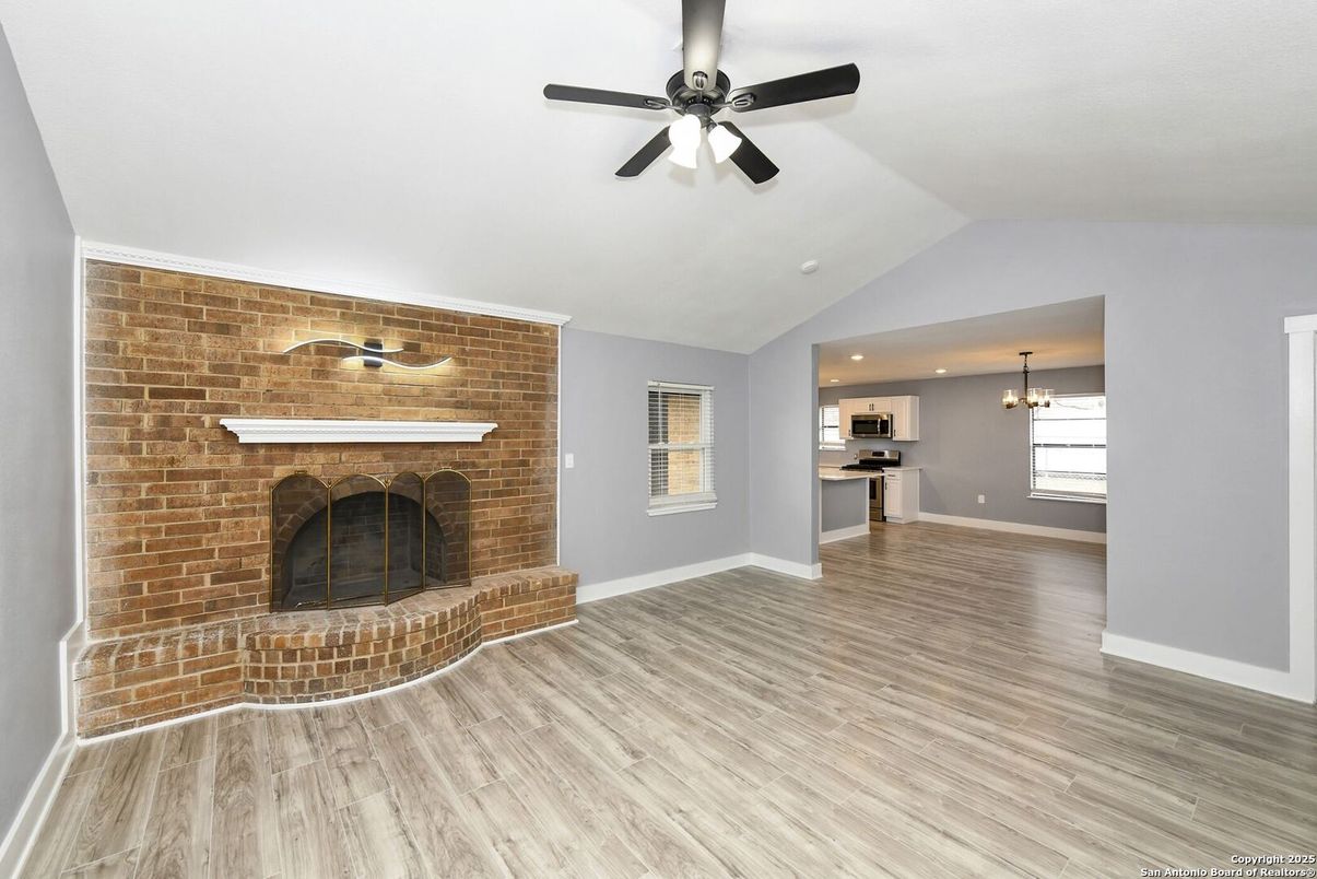 Empty room, Fireplace, Interior, Kitchen, Pendant Lights, Recessed Lighting, Stone Walls, Wood Texture Flooring