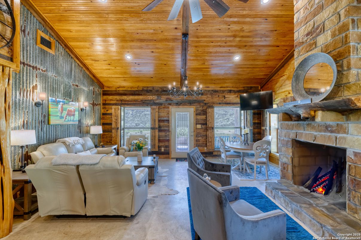 Chandelier, Dining room, Fireplace, Interior, Living room, Recessed Lighting, Stone Walls, Wooden Beams, Wooden Ceilings, Wooden Walls