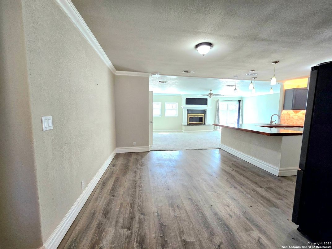 Empty room, Fireplace, Interior, Kitchen, Pendant Lights, Wood Texture Flooring