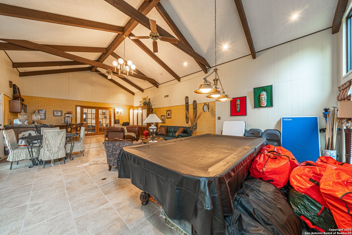Billiard Table, Chandelier, Dining room, Fireplace, Game Room, Interior, Living room, Pendant Lights, Recessed Lighting, Stone Walls, Wooden Beams