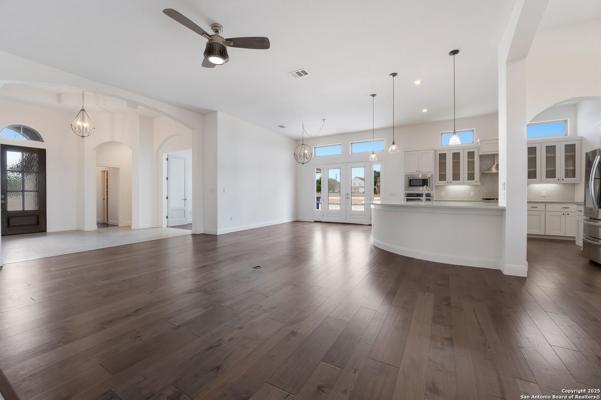 Empty room, Interior, Kitchen, Pendant Lights, Recessed Lighting, Stainless Steel Appliances, Wood Texture Flooring